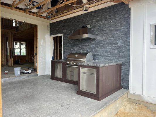 Finished with polished concrete countertop and stone wall