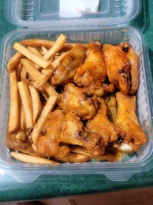 Garlic parm & Sweet Chili bone-in wings with fries.