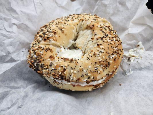 A toasted Everything Bagel with chive cream cheese.