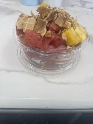 Acai fruit bowl - wild berry & peach Acai twist w/watermelon, mango, pineapple, crunched waffle cone and caramel drizzle.