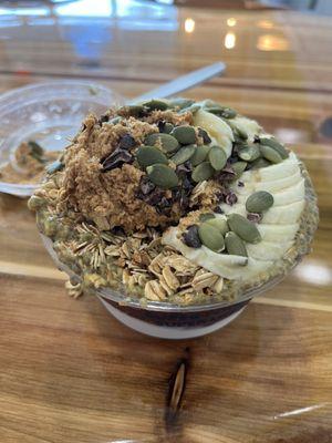 Loaded up seasonal pumpkin bowl (coconut and acai base, pumpkin spice chia seed pudding, cinnamon granola, banana, pumpkin seeds, PB)