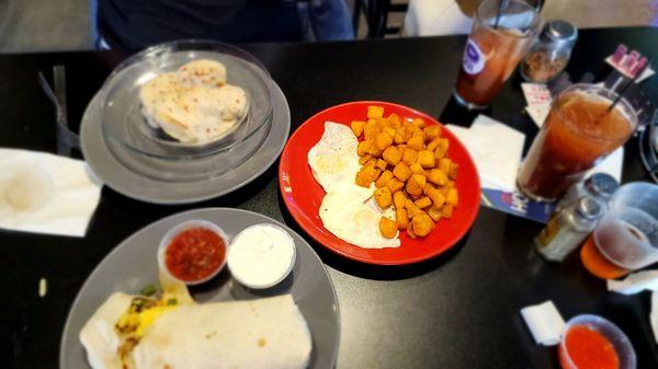 Atomic breakfast burrito and biscuits and gravy with eggs over easy and diced potatoes...