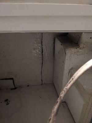 My upstairs neighbor's AC unit also leaking and pouring through this crack.