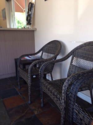 Comfy wicker chairs in waiting area