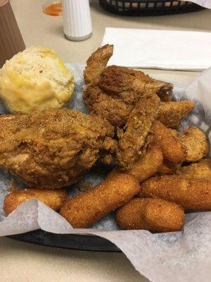 Two piece chicken meal with hush puppies and apple  fritters.