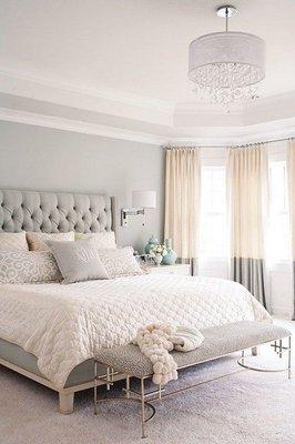 Master bedroom retreat is soft and soothing in cream and gray.  Windows are softened with beautiful banded drapery panels.