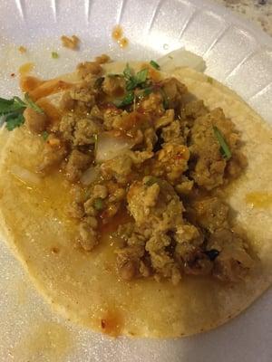 Chicken taco made with ground chicken, hot sauce and onions.