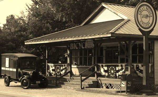 Great Bridge Cyclery's front porch with Roscoe parked nearby.