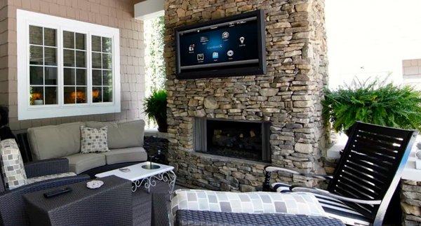 Outdoor patio TV above the fireplace installation.