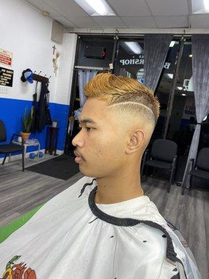 High fade with a stripe design and scissor cut on top