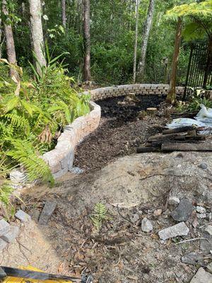 We put up the retaining wall but needed dirt brought in and leveled out.