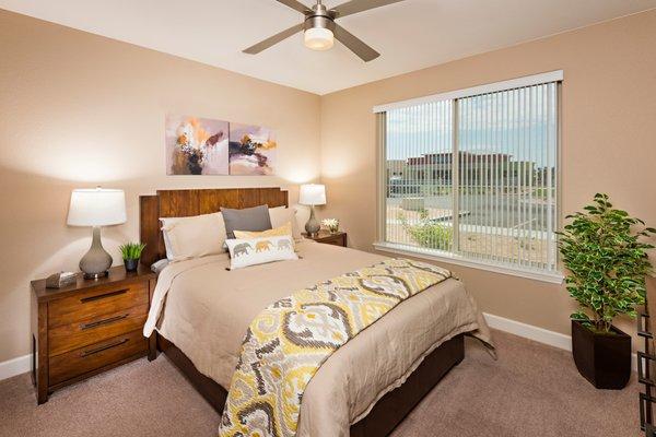 Bedroom with lighted ceiling fan at Southern Ave Villas