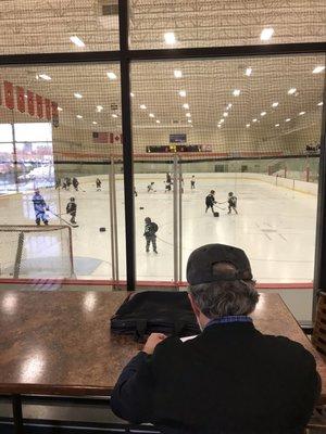 Tables rink side yet inside heated common area.