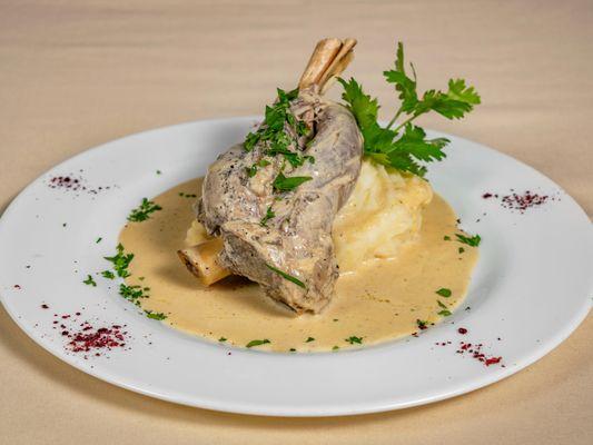 Lamb shank, served over creamy mashed potatoes and Dijon mustard cream sauce.