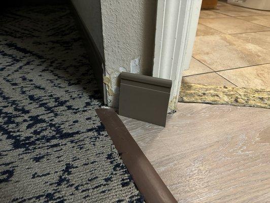 A baseboard that had been ripped off the wall and left that way