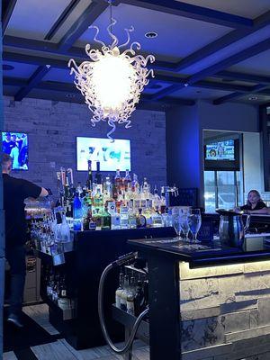 Bar with frozen coaster plate and cool light fixture.