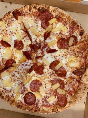 Pizza with pepperoni and pineapple