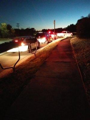 Cars lined up on Hunter Road waiting to order food from Gill's Chicken.