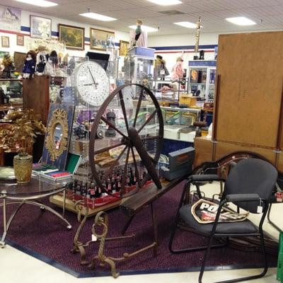 An honest-to-goodness spinning wheel. Wow. Behind it is a clock with each hour marked individually.