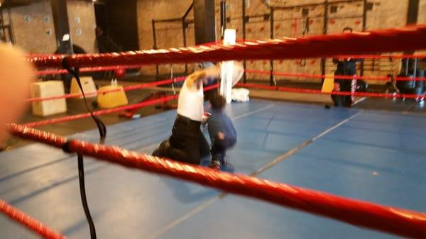 Striking coach with a young MMA fighter in training