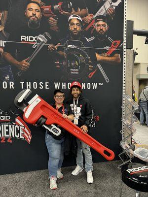 This my son and I at a trade show if you look close he is on the ridgid billboard behind us .