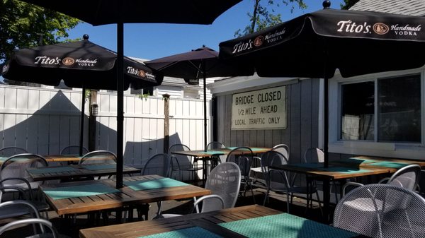 Several tables and umbrellas. This is about half the patio.