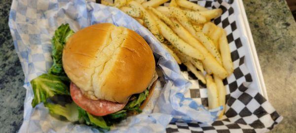 Beef burger with crispy onion chips and garlic fries on side