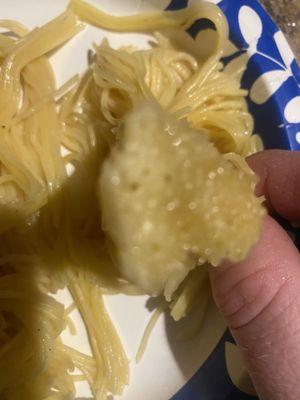 Raw capellini pasta.