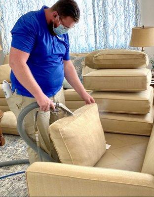 David at work, steaming one of our couches.