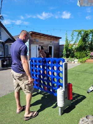 A game of Connect Four on a sunny day.