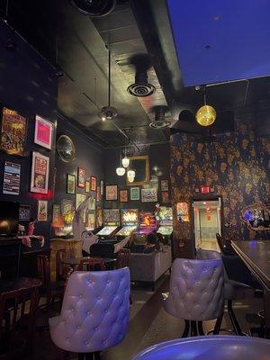 inside decor with pinball machines, as divey as it can get