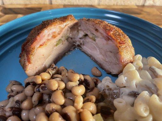 Bacon-wrapped boneless stuffed chicken thighs with jalapeños and pepper Jack cheese (served with Mac & cheese and black-eyed peas)