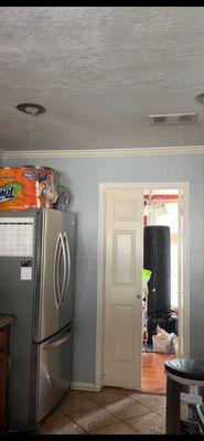 Water leaks through the ceiling into kitchen area