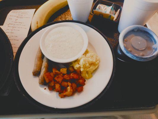 breakfast: scrambled egg, grits, turkey sausage, seasony taters, thin decaf coffee, cold water, hot water for tea, and a banana