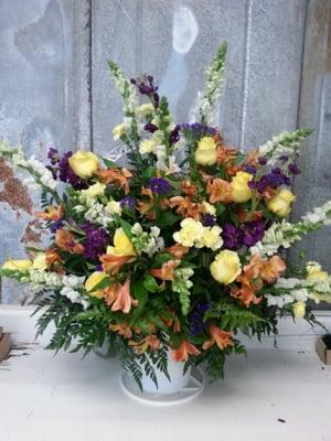 Handled basket funeral  tribute. Snap dragons, roses and alstroemeria.