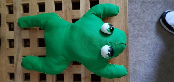 After photo of the restored frog with new green fabric stuffed with soft squishy pom poms.