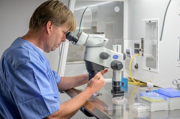 Tissue Bank Director Corey Burke working in the embryology lab to cryopreserve eggs