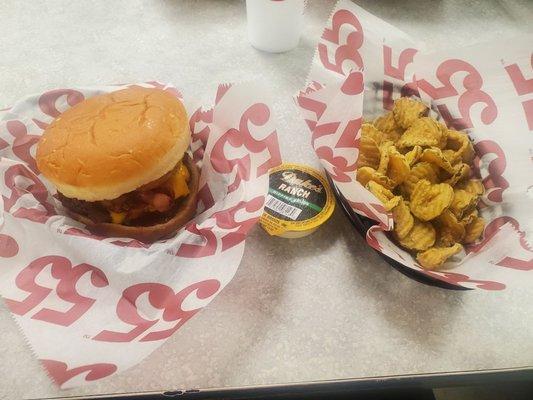 My burger with bacon and onion rings and the side fried pickles