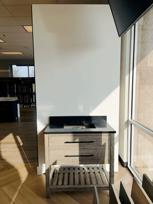 Modern vanity with rich wood finish and sleek black countertop--an elegant upgrade for any bathroom remodel.