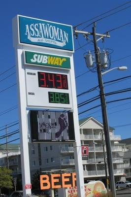 sign shows gas price and subway store