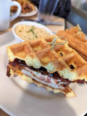 Chicken and Waffle Sandwich. $18.50. Freshly-made waffle topped with fried chicken breast, pimento cheese, jalapeno jam, and bacon. Grits.