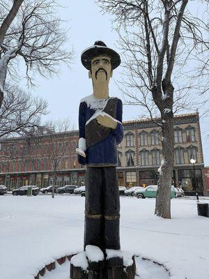 Statue with plaza in background. The whole building is the hotel.