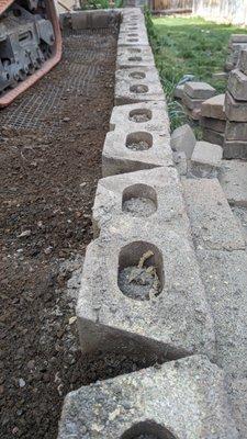 Once System Pavers started removing the paver stones, some of the glaring defects became apparent, like this crooked wall.