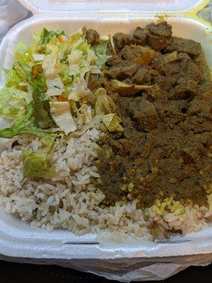 Curried goar with pigeon peas and rice and salad