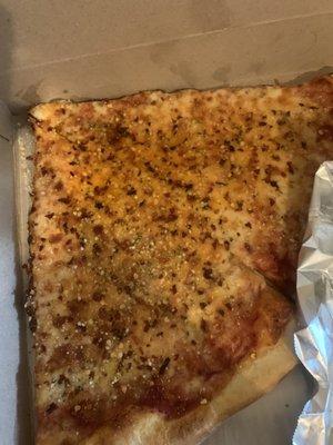 Two Slices of Cheese Pizza with Oregano, Chili Flakes and Parmesan Cheese