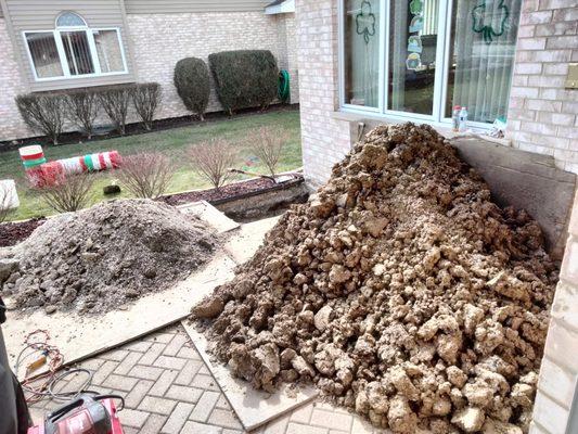 Pile of dirt and stone while they worked on the plumbing issue.