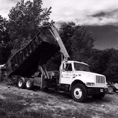 Grapple truck.  "Our grapple truck will pick up large logs and limbs and haul them off."   25yd box on this unit!