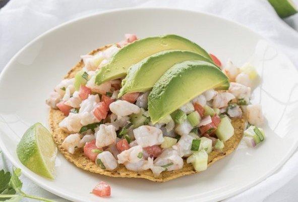 Ceviche tostadas! Fried tortilla served with fish cooked with lime and pico de gallo and avocado