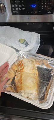 A chorizo chicken burrito with rice the size of my face