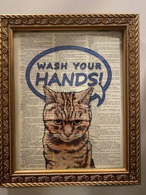 Liked this artwork idea: page out of a dictionary with a cute cat artwork overlay in the restroom.